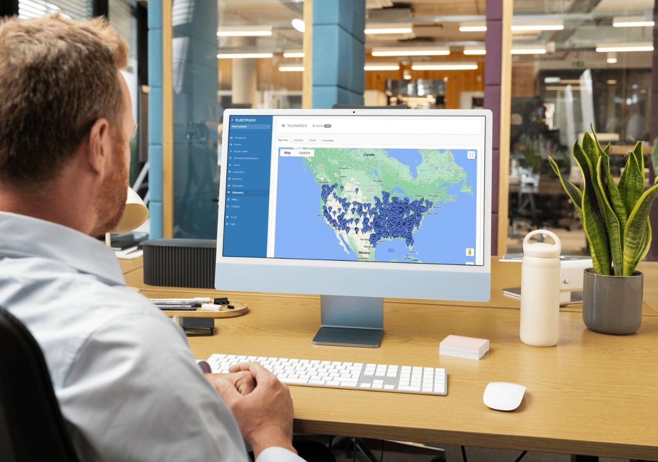 Fleet manager viewing the Fleetrock telematics map showing connected vehicles across North America